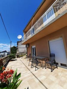 a patio with chairs and a table on a balcony at Lana 2 in Senj