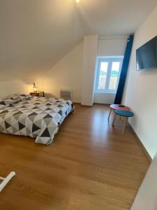 a bedroom with a bed and a wooden floor at La Résidence du Canal de Bourgogne in Montbard