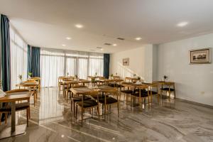 a dining room with wooden tables and chairs at Graphica Black Sea in Shekhvetili