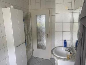 a small bathroom with a sink and a shower at Silkes FeWo 