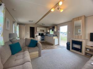 a living room with a couch and a fireplace at The Hideaway in Cayton