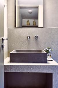 a sink in a bathroom with a counter top at Nikolaou residence in Aegina Town