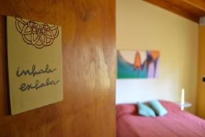 a bedroom with a bed and a sign on a door at El Nogal in Sierra de la Ventana