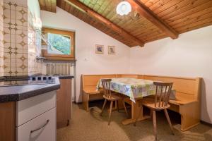 a kitchen and dining room with a table and chairs at Ciasa La Palsa App 4 in San Vigilio Di Marebbe