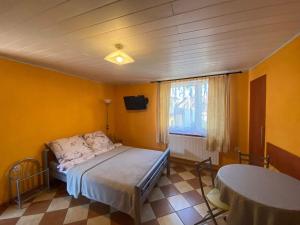 a bedroom with a bed in a room with yellow walls at Pokoje goscinne Marcin in Łeba
