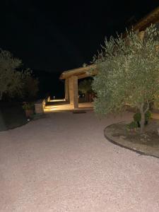 a patio at night with a building in the background at Caiferri Agriturismo in Gubbio