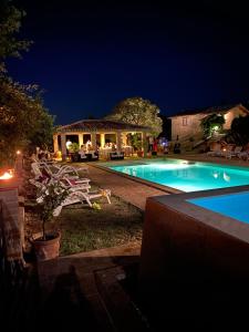 a swimming pool in a yard at night at Caiferri Agriturismo in Gubbio