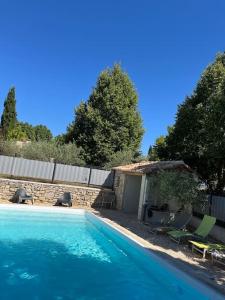 a swimming pool in a yard with a house at DOMAINE MARY'S in Barjac