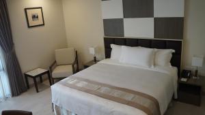A bed or beds in a room at Hotel Parami