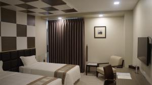 A bed or beds in a room at Hotel Parami
