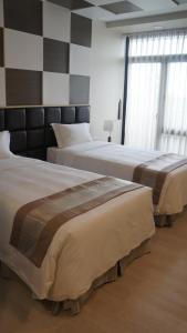 A bed or beds in a room at Hotel Parami