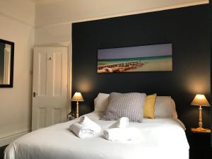 una camera da letto con un letto bianco con due asciugamani di Bright Spacious 3-bed with office & patio, Preston a Preston