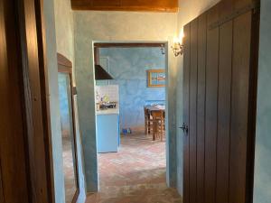 a kitchen with a blue refrigerator and a table at Caiferri Agriturismo in Gubbio