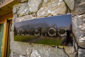 a sign on a stone wall with the word education at Finca La Suerte Grande in Telde