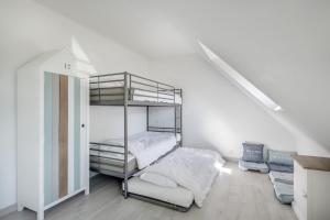 a bedroom with a bunk bed and a staircase at Maison vue mer dans le Golfe du Morbihan in Baden