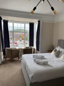 a bedroom with a large bed and a large window at Bodalwyn Guest House in Aberystwyth