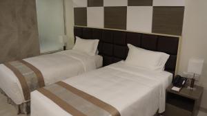 A bed or beds in a room at Hotel Parami