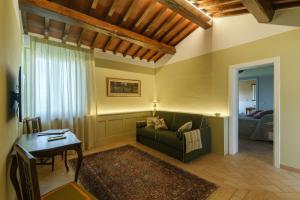 a living room with a couch and a table at Fattoria Di Pancole in San Gimignano