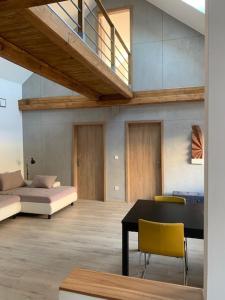 a living room with a bed and a table and chairs at Loft Pihenő és Wellness Ház in Balatonfüred