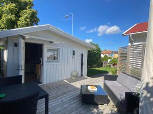 a patio with a couch and a shed at Eklanda Studio in Gothenburg