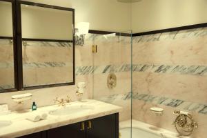 a bathroom with a sink and a shower at Hotel la Ponche in Saint-Tropez