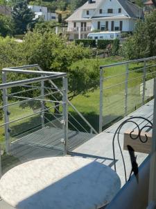 a bench sitting on the deck of a house at Le clos des Pommiers in Uffholtz