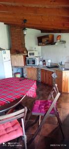 a kitchen with a table and chairs in a room at Guest House Sunrise in Shabla