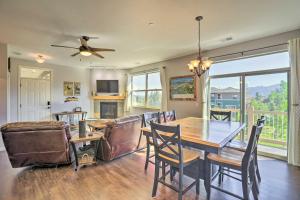 a dining room with a table and chairs and a couch at Stunning Fraser Condo Less Than 8 Mi to Winter Park! in Fraser