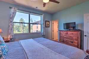 a bedroom with a bed and a tv and a window at Stunning Fraser Condo Less Than 8 Mi to Winter Park! in Fraser