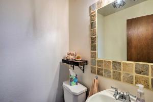 a bathroom with a sink and a mirror and a toilet at Grand Junction Townhome about 3 Mi to Downtown! in Grand Junction +22 photos