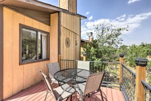a patio with a table and chairs on a deck at Grand Junction Townhome about 3 Mi to Downtown! in Grand Junction