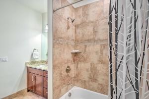 a bathroom with a shower with a tub and a sink at 7 Mi to Arapahoe Basin Ski Area Keystone Condo in Keystone +20 photos