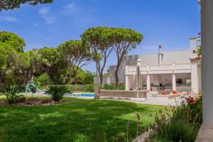a view of a house with a yard at Portuguese mansion close to marina, golf and beach. in Vilamoura