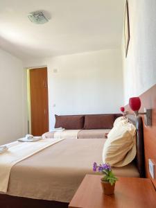 a hotel room with a bed and a couch at Apartments Fat e Jet in Ulcinj