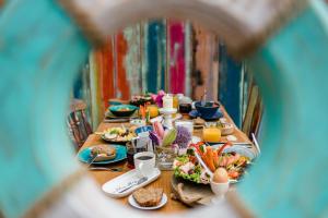 a table with plates of food on it at feels Beach Club Hotel in Kühlungsborn