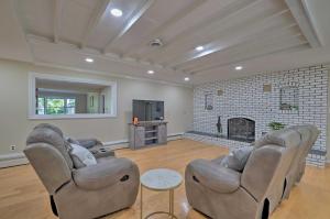 a living room with two couches and a fireplace at Coastal Edgewater Home with Private Hot Tub! in Annapolis
