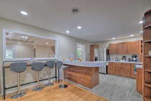 a kitchen with a counter and some bar stools at Coastal Edgewater Home with Private Hot Tub! in Annapolis