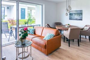 a living room with a couch and a table at Zweite Heimat Apartment 2 in Lohme