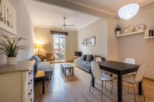 a living room with a table and a couch at 23PAR1007 Comfortable apartment in Paralel in Barcelona