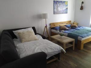 a bedroom with two beds and a table with a lamp at PISQOR Apartment - self check-in in Bratislava