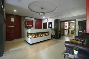 a living room with a couch and a fireplace at Beryll Inn Cyberjaya Hotel in Cyberjaya