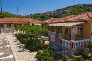 una casa con un sacco di fiori davanti di ANEMI APARTMENTs a Finikounta