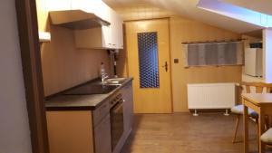 a kitchen with a sink and a counter top at Dachstübchen an der Oder in Neuglietzen +18 photos