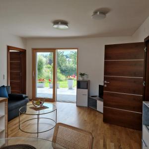 a living room with a couch and a table at Comfy Plaza 