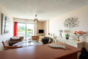 a living room with a dining table and a living room at Jonc de Mer in Saint-Cast-le-Guildo