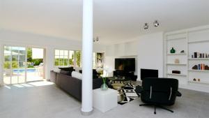a living room with a couch and a chair at Vila Castro-Cleverdetails, Quiet area, private pool in Vilamoura