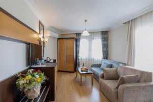 a living room with a couch and a table at Kandelor Hotel in Alanya