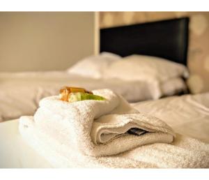 a white towel sitting on top of a bed at Number 19 Brighton in Brighton & Hove