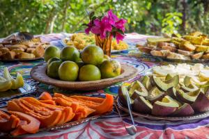 a table with plates of food on top of it at Sítio Monte Alegre in Ibicoara