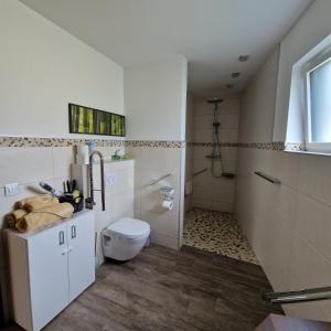 a white bathroom with a toilet and a shower at Comfy Plaza 